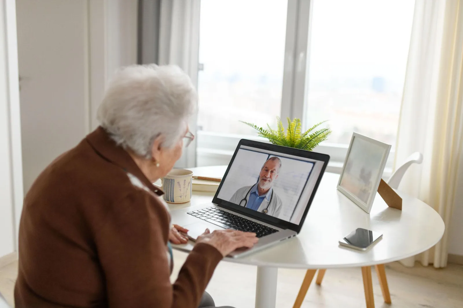Patient using a laptop for a telehealth appointment at home